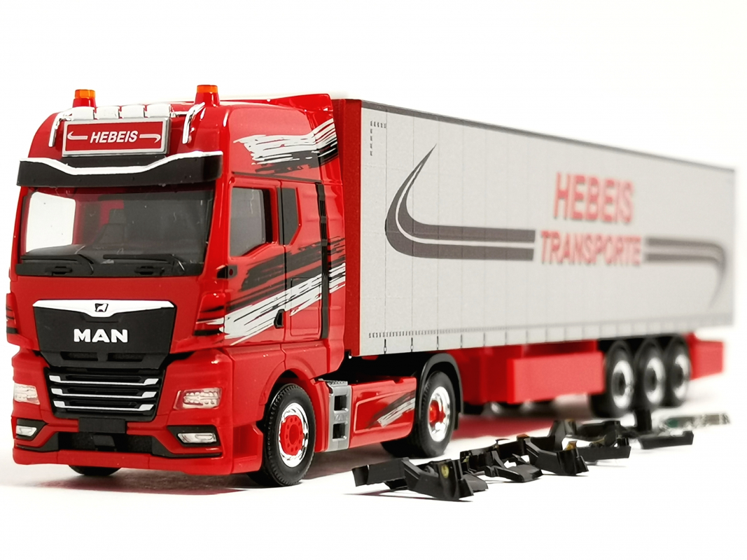Preview: 320498 MAN TGX GX Gardinenplanen-Sattelzug "Hebeis Transporte" Herpa