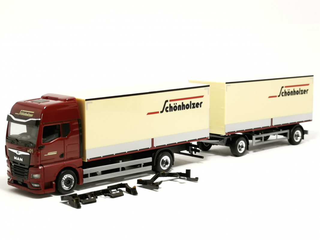 962223 MAN TGX GX Koffer-Hängerzug (Pritsche/Plane gedruckt) "Schönholzer" Herpa